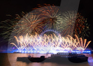 25th Anniversary of London’s New Year’s Eve fireworks display as seen from the RAF Memorial on the Embankment overlooking the river Thames towards the Coca-cola London Eye. 
31st December 2024