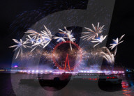 25th Anniversary of London’s New Year’s Eve fireworks display as seen from the RAF Memorial on the Embankment overlooking the river Thames towards the Coca-cola London Eye. 
31st December 2024