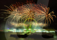 25th Anniversary of London’s New Year’s Eve fireworks display as seen from the RAF Memorial on the Embankment overlooking the river Thames towards the Coca-cola London Eye. 
31st December 2024