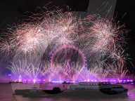 25th Anniversary of London’s New Year’s Eve fireworks display as seen from the RAF Memorial on the Embankment overlooking the river Thames towards the Coca-cola London Eye. 
31st December 2024