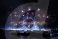 25th Anniversary of London’s New Year’s Eve fireworks display as seen from the RAF Memorial on the Embankment overlooking the river Thames towards the Coca-cola London Eye. 
31st December 2024
