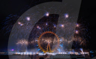 25th Anniversary of London’s New Year’s Eve fireworks display as seen from the RAF Memorial on the Embankment overlooking the river Thames towards the Coca-cola London Eye. 
31st December 2024
