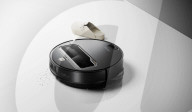 Robot vacuum cleaner has arm for picking up old socks and tissues
