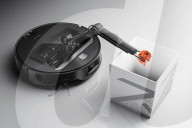 Robot vacuum cleaner has arm for picking up old socks and tissues