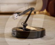 Robot vacuum cleaner has arm for picking up old socks and tissues