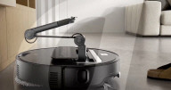 Robot vacuum cleaner has arm for picking up old socks and tissues