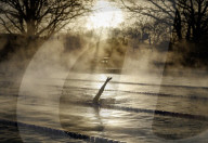 Swimmers brave cold temperatures to exercise in Hampton outdoor heated pool in south west London, UK. 