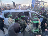 Palestinians view handover of Israeli hostages to ICRC