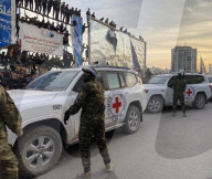 Palestinians view handover of Israeli hostages to ICRC