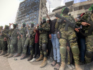 Palestinians view handover of Israeli hostages to ICRC