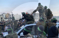 Palestinians view handover of Israeli hostages to ICRC