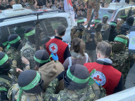 Palestinians view handover of Israeli hostages to ICRC