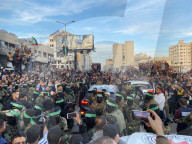 Palestinians view handover of Israeli hostages to ICRC