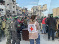 Palestinians view handover of Israeli hostages to ICRC