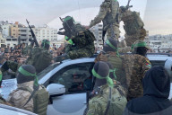 Palestinians view handover of Israeli hostages to ICRC
