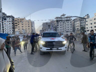 Palestinians view handover of Israeli hostages to ICRC
