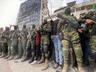 Palestinians view handover of Israeli hostages to ICRC
