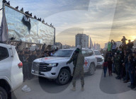 Palestinians view handover of Israeli hostages to ICRC
