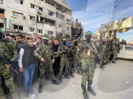 Palestinians view handover of Israeli hostages to ICRC