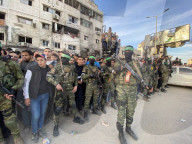 Palestinians view handover of Israeli hostages to ICRC