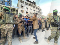 Palestinians view handover of Israeli hostages to ICRC