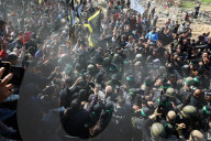 Hamas forces Israeli female hostage thru mob of armed men in dangerous propaganda display
