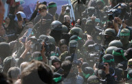 Hamas forces Israeli female hostage thru mob of armed men in dangerous propaganda display