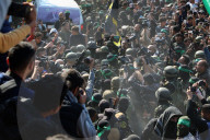 Hamas forces Israeli female hostage thru mob of armed men in dangerous propaganda display