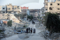Palestinians amidst Gaza City rubble