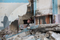 Palestinians amidst Gaza City rubble
