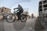 Palestinians amidst Gaza City rubble