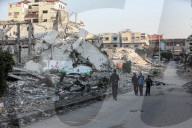 Palestinians amidst Gaza City rubble