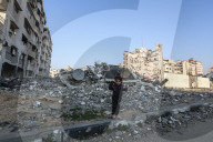 Palestinians amidst Gaza City rubble
