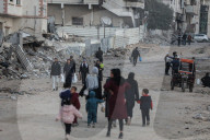 Palestinians amidst Gaza City rubble
