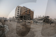 Palestinians amidst Gaza City rubble