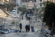 Palestinians amidst Gaza City rubble
