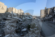 Palestinians amidst Gaza City rubble