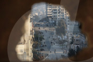 Palestinians amidst Gaza City rubble
