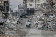 Palestinians amidst Gaza City rubble
