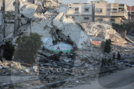 Palestinians amidst Gaza City rubble