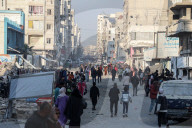 Palestinians amidst Gaza City rubble