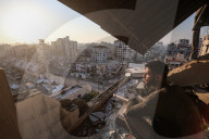 Palestinians amidst Gaza City rubble