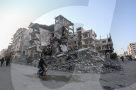 Palestinians amidst Gaza City rubble