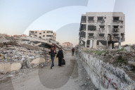Palestinians amidst Gaza City rubble