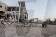 Palestinians amidst Gaza City rubble