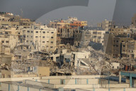 Palestinians amidst Gaza City rubble