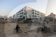 Palestinians amidst Gaza City rubble