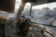 Palestinians amidst Gaza City rubble