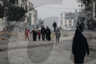 Palestinians amidst Gaza City rubble