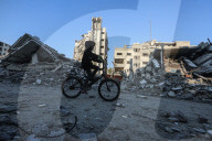 Palestinians amidst Gaza City rubble
